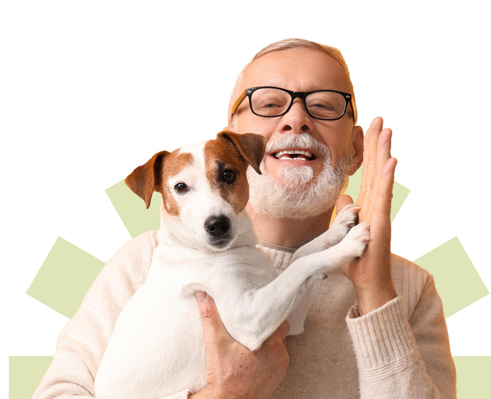 Man holding a small dog with a plain background